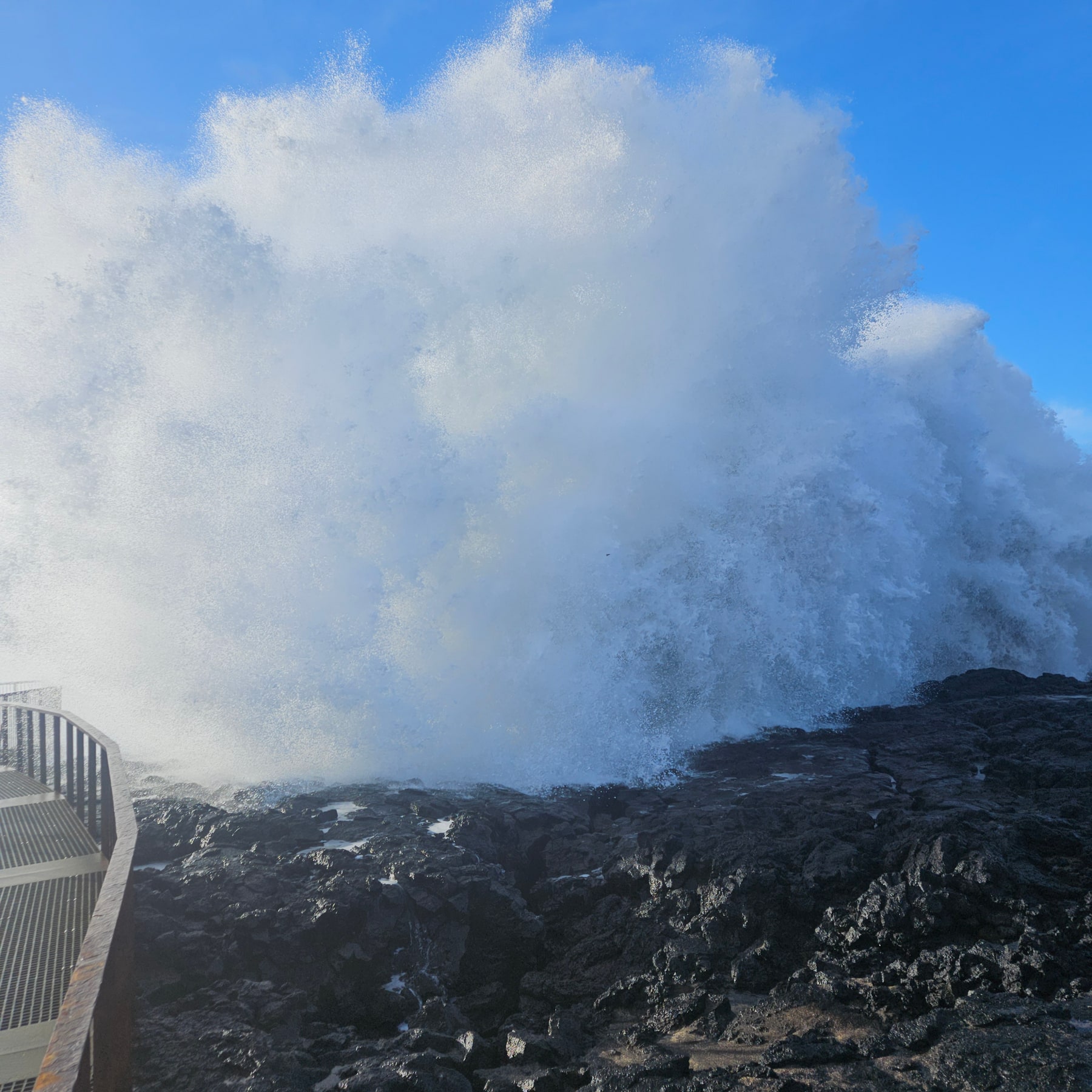 A huge wave exploding against the black lava coast at Brimketill in Iceland