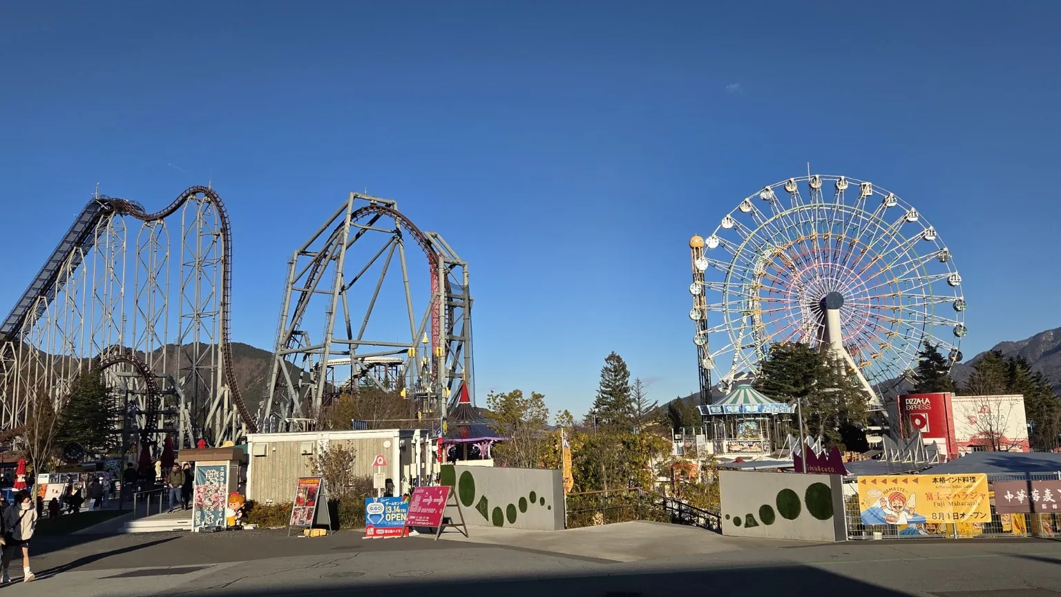 Roller coasters and the Ferris wheel at Fuji-Q Highland under a clear winter sky