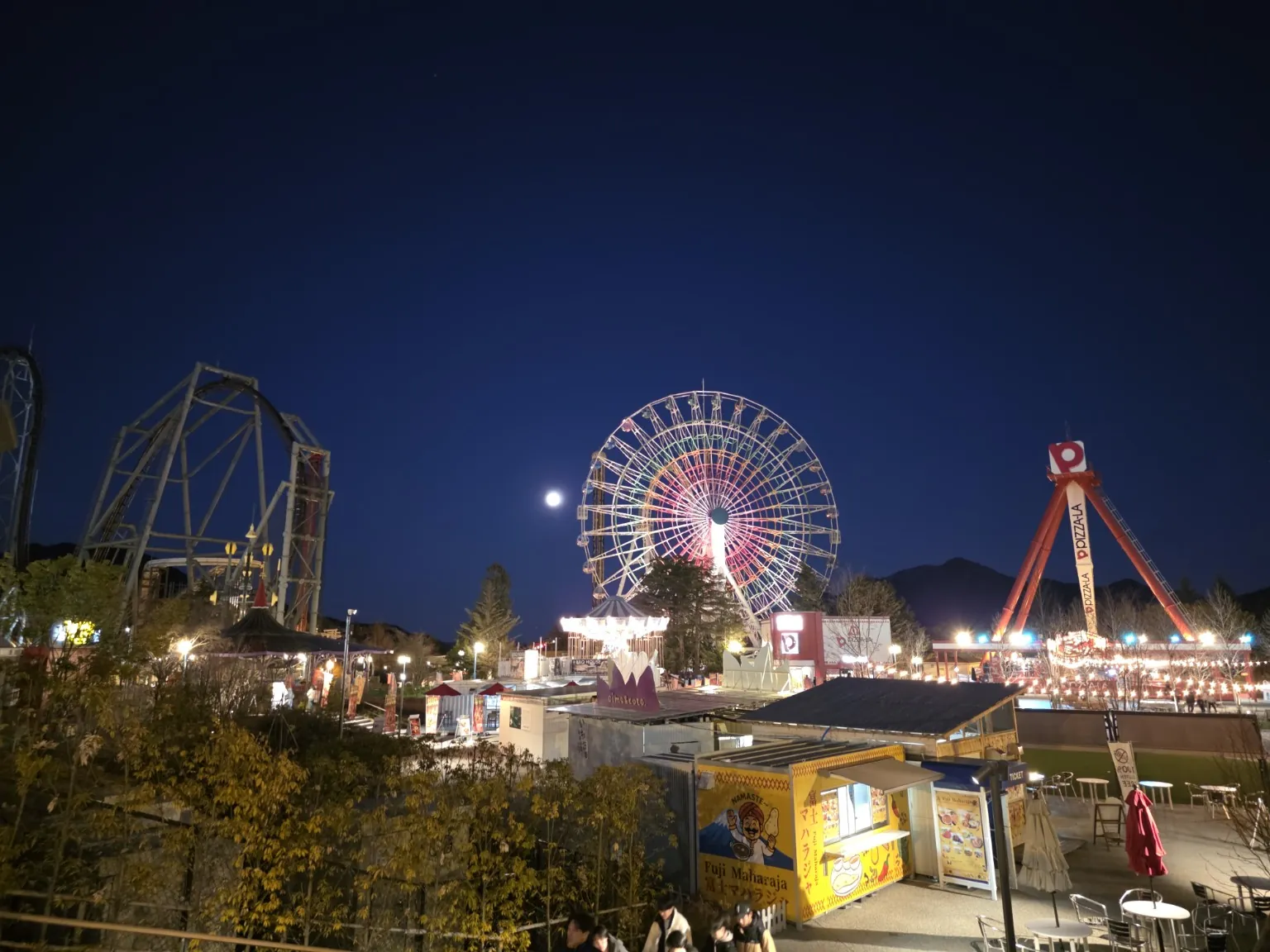 Fuji-Q Highland at night with the Ferris wheel and rides illuminated