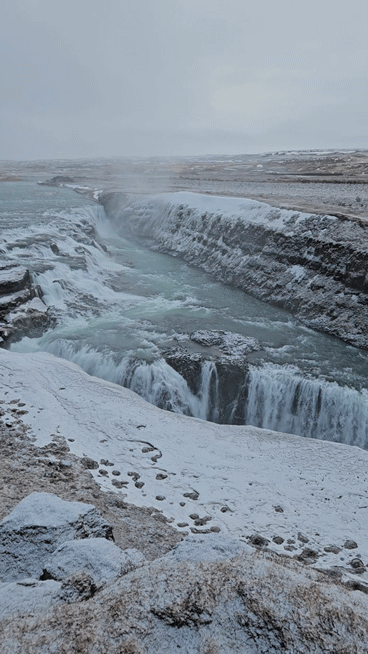 The broad flow of Gullfoss continuing over several rocky steps