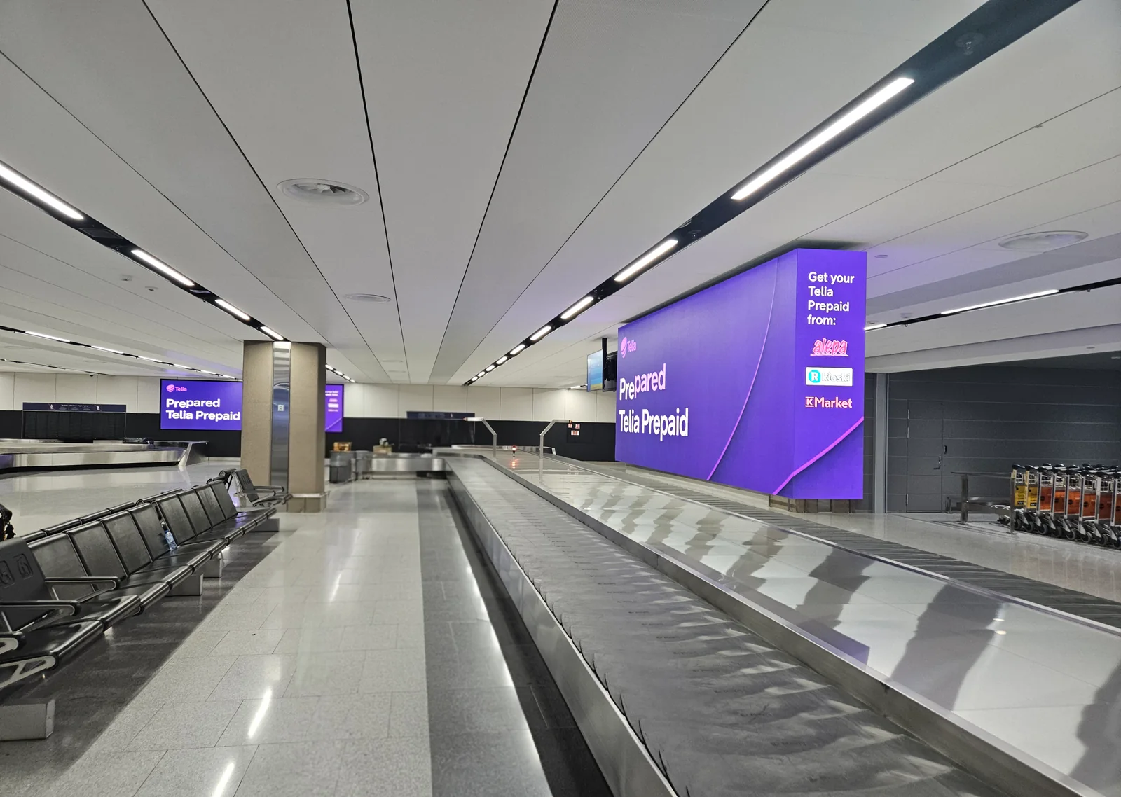 Baggage claim hall and arrivals signage at Helsinki Airport