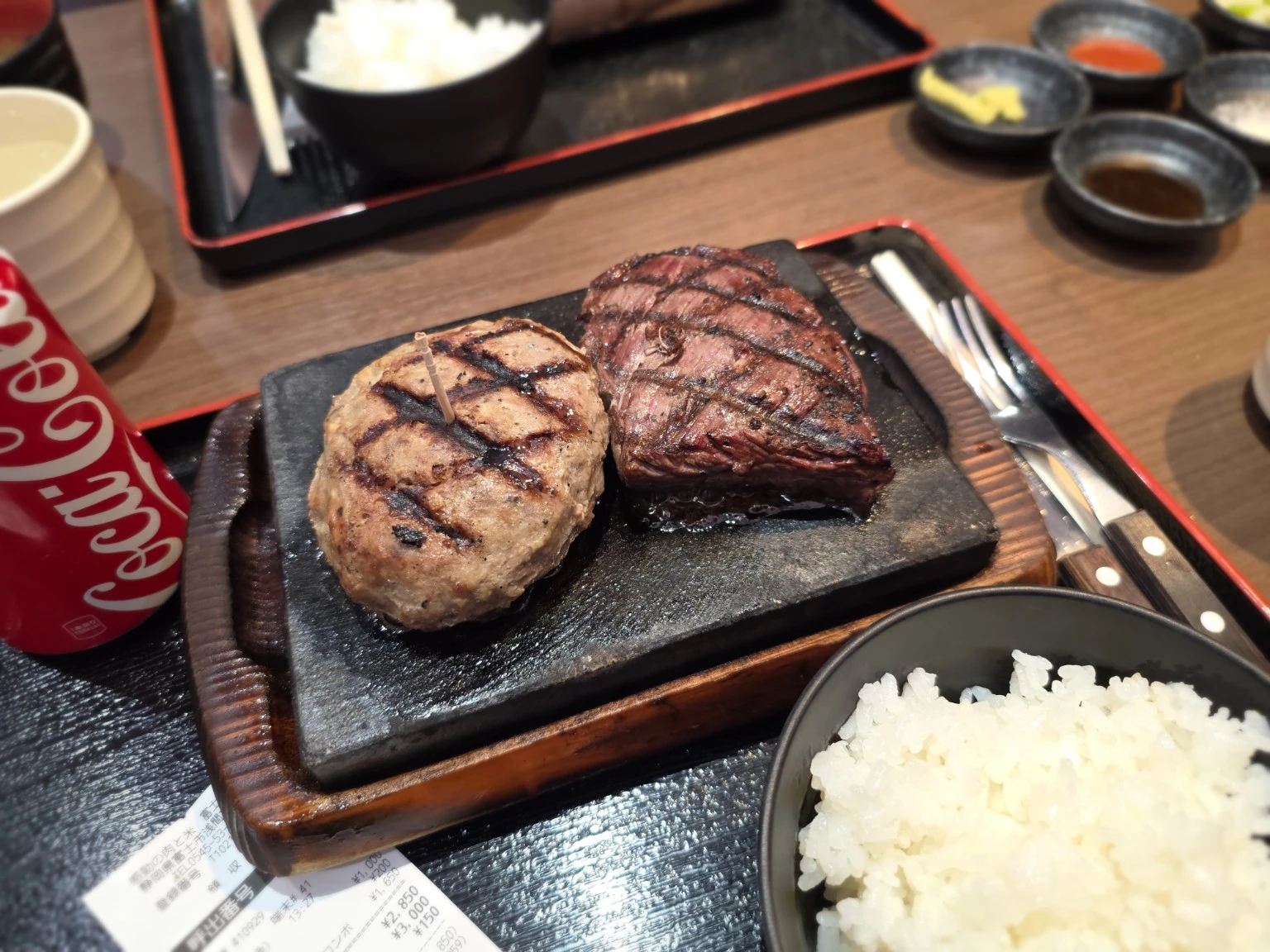 Hamburg steak and steak sizzling on a hot plate at Kando no Niku to Kome Fujiyoshiwara in Fuji