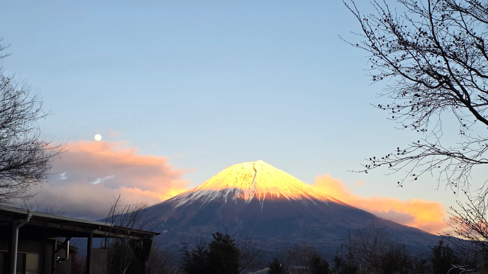 Mount Fuji glowing at sunset beneath pink clouds on the road toward Lake Tanuki