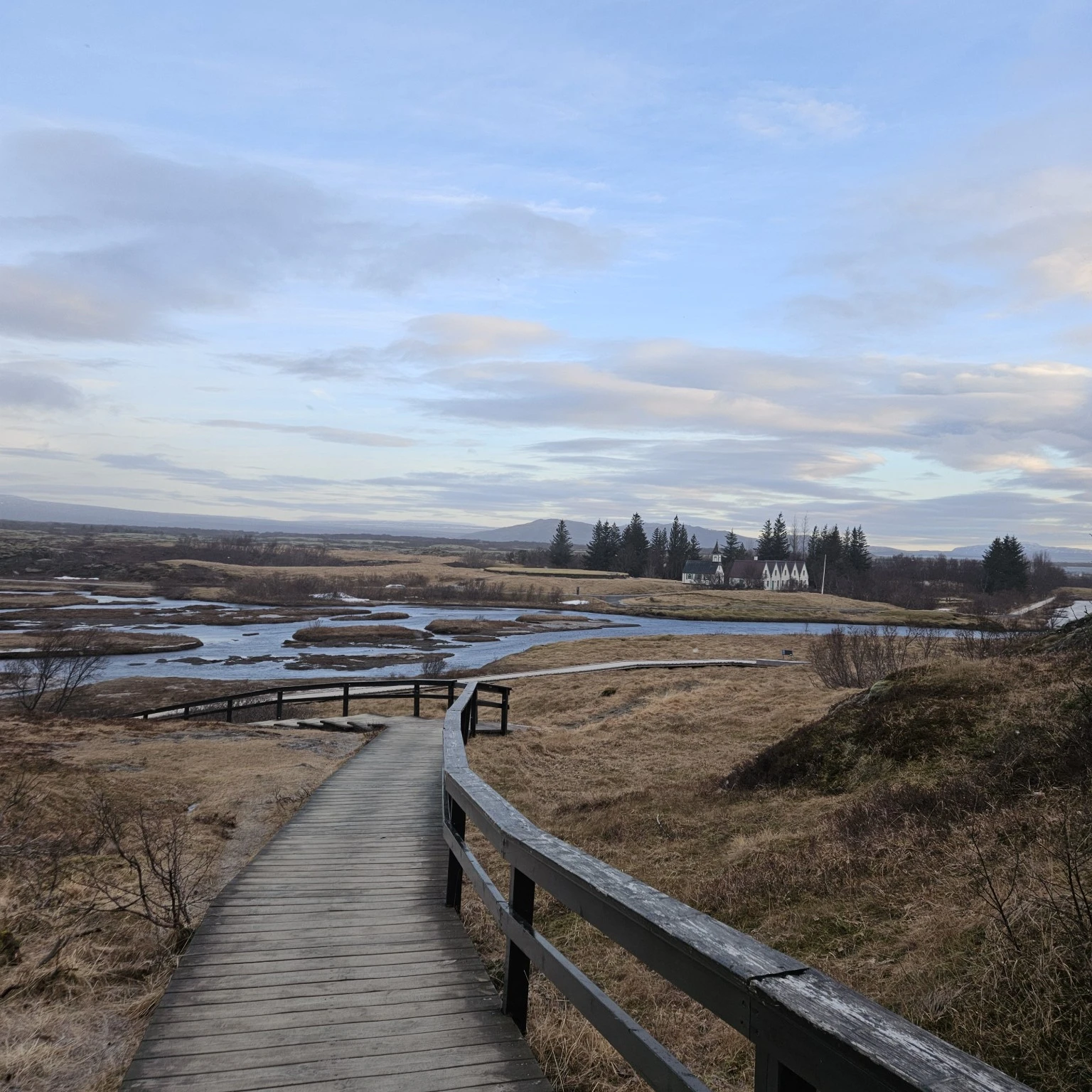 Boardwalk leading across the open fields toward Þingvellir Church