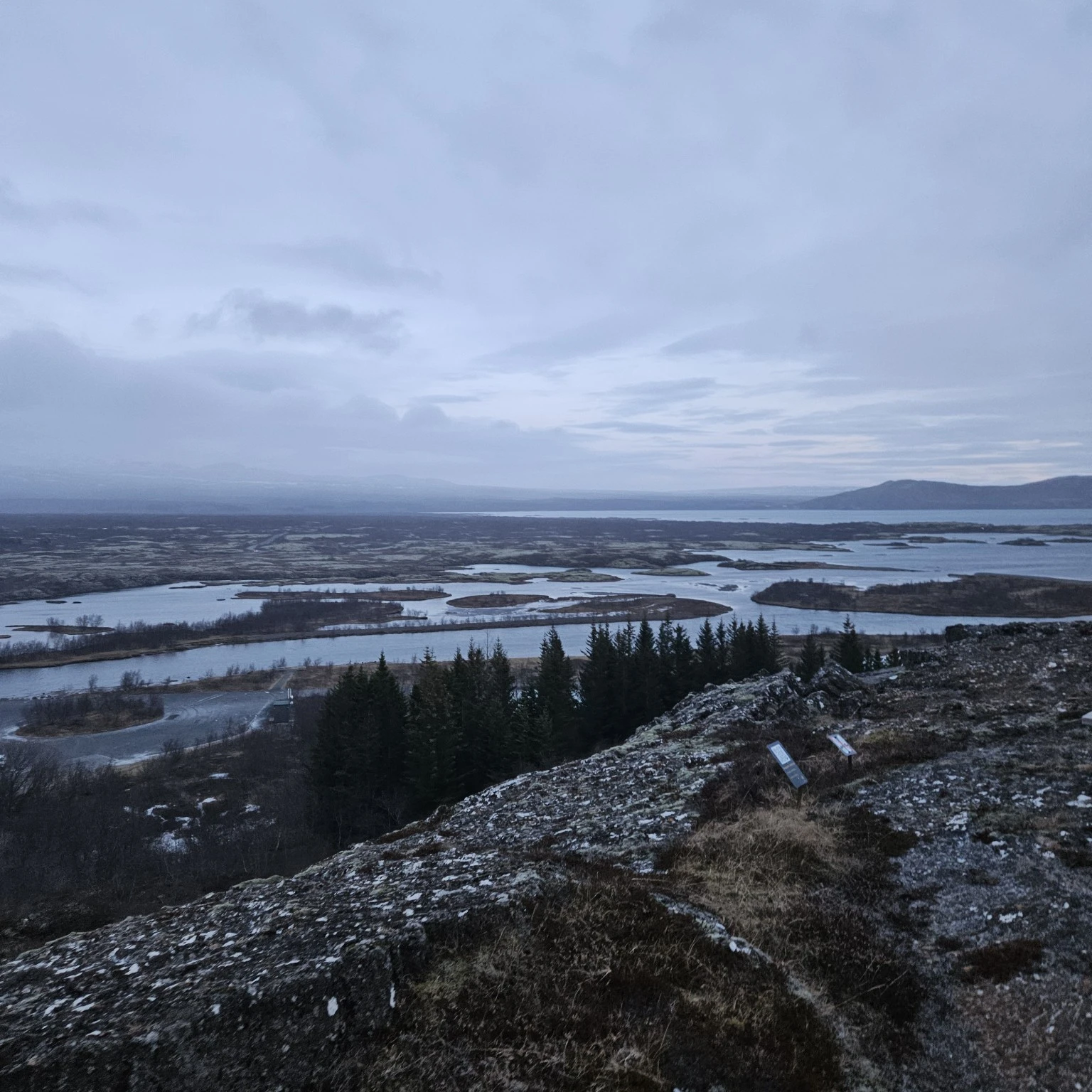 A darker snowy view across Þingvellir late in the walk